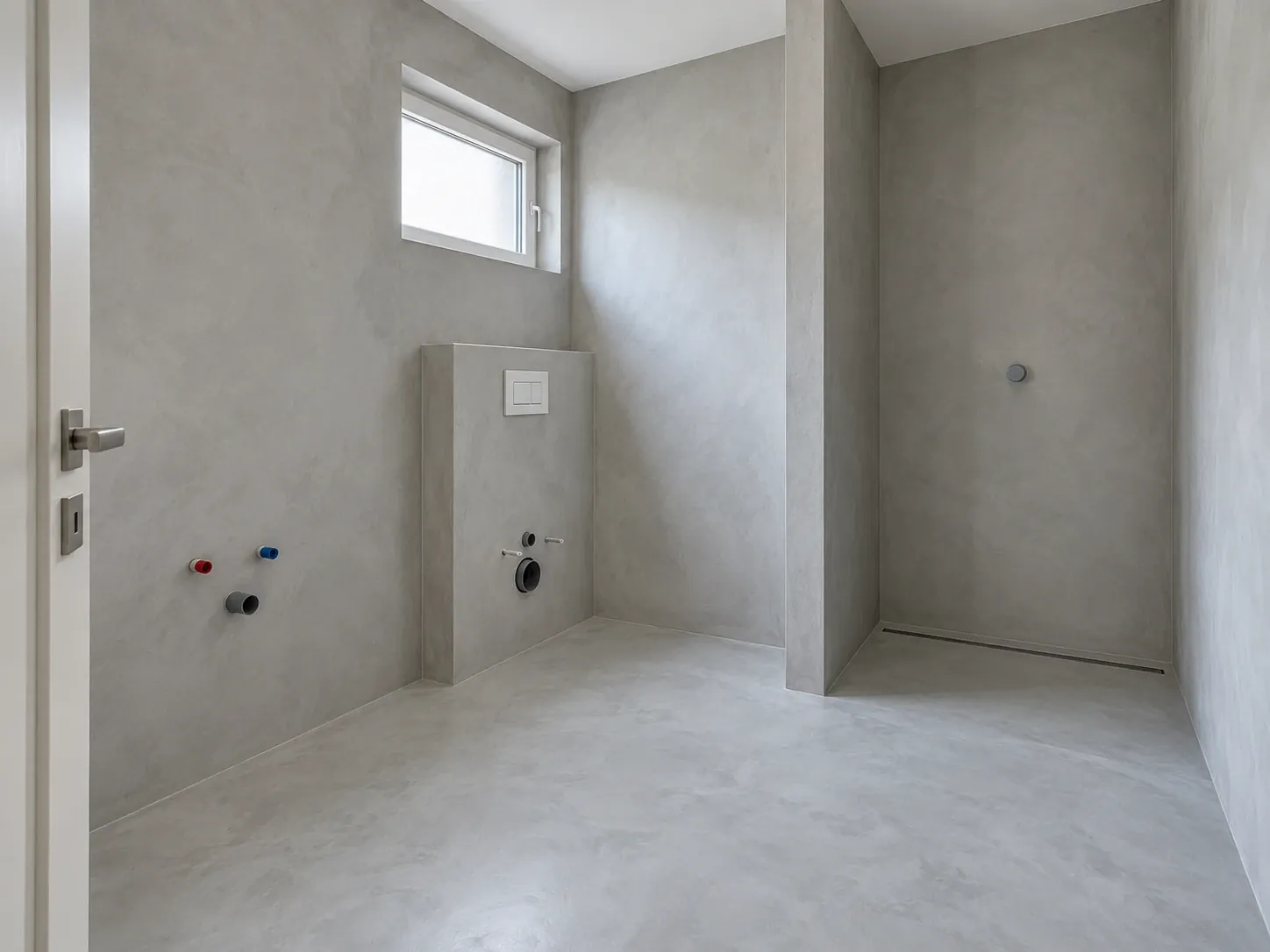 Light grey microcement bathroom with a walk-in shower and linear drain, walls and floor without joints